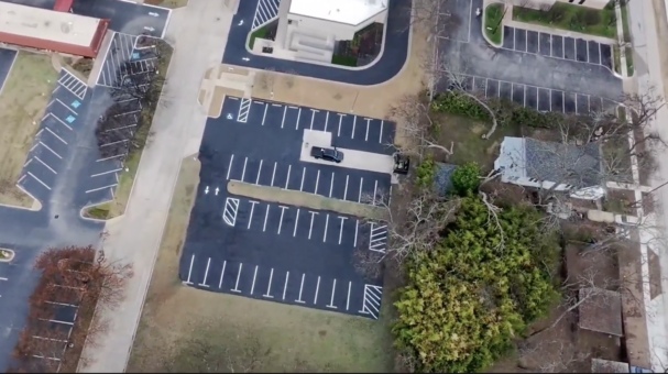 dfw asphalt sealcoating company applies a fresh sealcoat