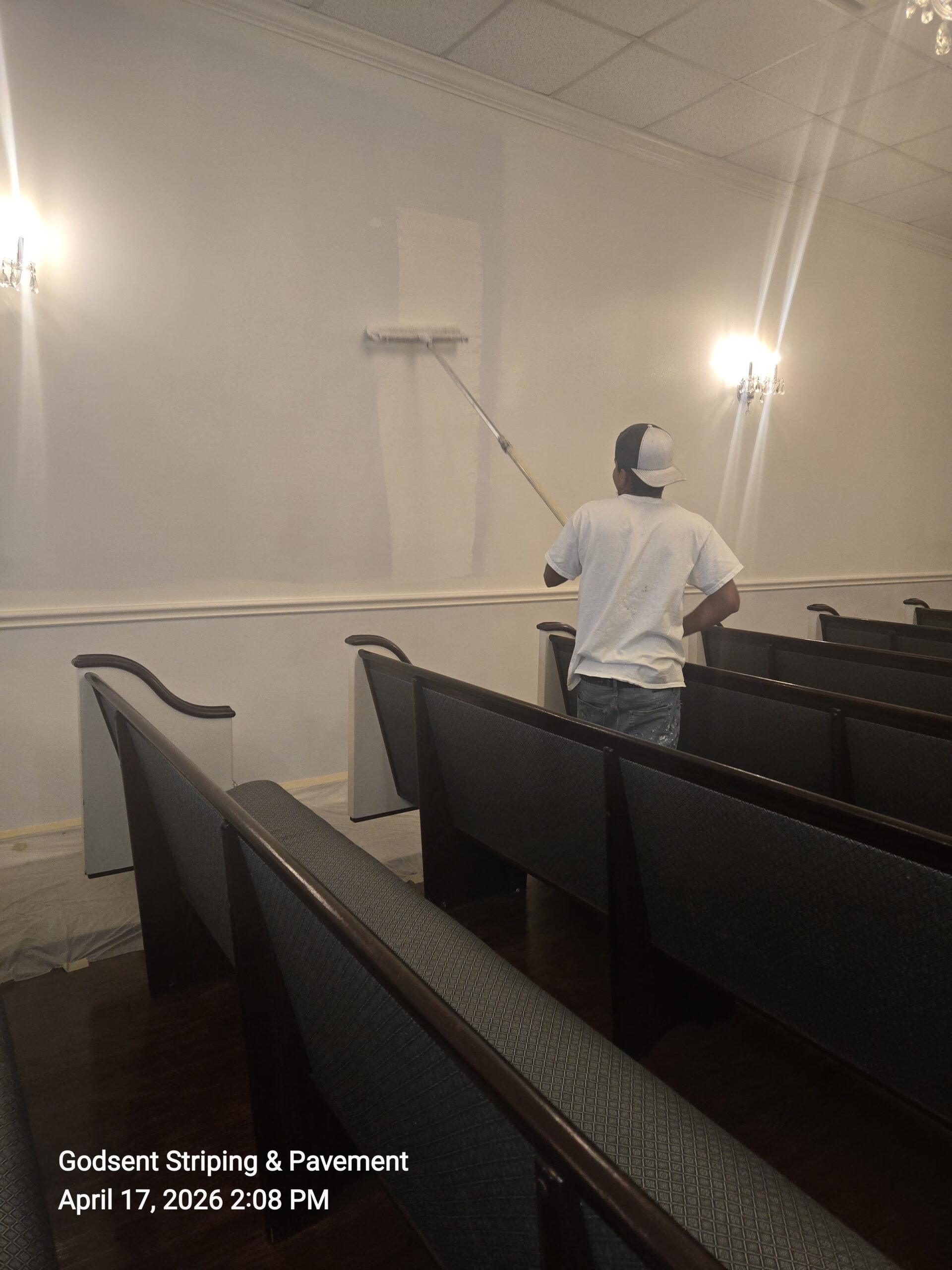 Team member painting a commercial interior wall